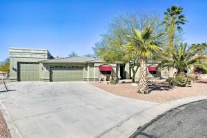 a house with a palm tree and a driveway at Lake Havasu City Vacation Rental with Pool! in Lake Havasu City