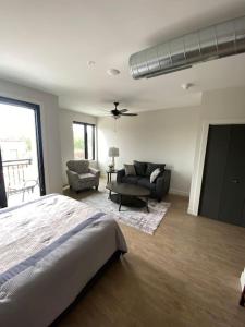 a bedroom with a bed and a living room at Luxury River-Front Handicap Accessible Studio Apt in Davenport