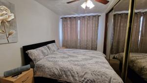 a small bedroom with a bed and a mirror at Shergold House in Swindon