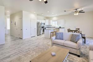 a living room with a couch and a table at Modern Kingman Vacation Rental, 5 Mi to Dtwn! in Kingman