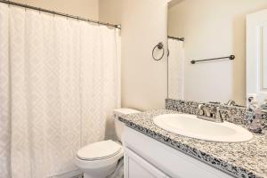 a bathroom with a sink and a toilet and a shower at Modern Kingman Vacation Rental, 5 Mi to Dtwn! in Kingman +18 photos
