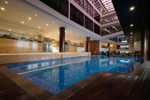 a large swimming pool in the middle of a building at Dream of Aventus Hotel Kuta in Kuta
