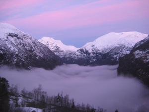 a view of a mountain range with snow covered mountains at Lunheim in Geiranger in Geiranger