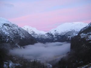 a view of a mountain range with snow covered mountains at Lunheim in Geiranger in Geiranger