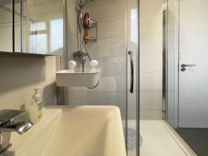 a bathroom with a sink and a shower at Nelly's Place hosted by AirOperate in Wealdstone