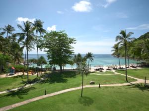 an aerial view of a park with palm trees and the ocean at Phuket Marriott Resort & Spa, Merlin Beach in Patong Beach