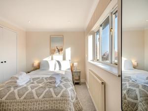 a bedroom with a bed and a mirror at Beaches in Overstrand