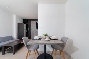 a dining room with a table and chairs at Central Hill View A901 A in Kathu
