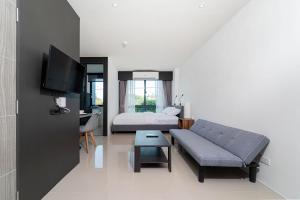 a living room with a couch and a bed at Central Hill View A901 A in Kathu
