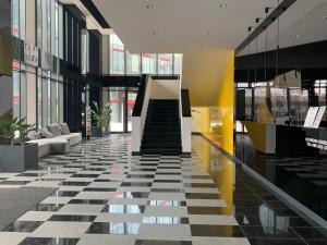 a lobby with a black and white checkered floor at Fillhus Apartments in Poznań