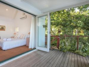 a bedroom with a bed and a sliding glass door at Elgin Country Cottage in Elgin