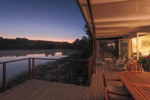 a house with a deck with a view of a river at Elgin Country Cottage in Elgin