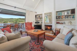 a living room with a couch and a fireplace at Elgin Country Cottage in Elgin