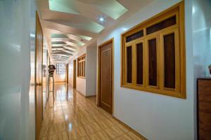 a hallway in a house with a person taking a picture at Hostal Casa Pajaritos in Taxco de Alarcón