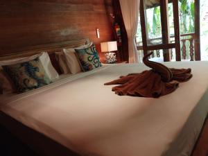 a bed with a towel sitting on top of it at Ocean Prana Village in Amed