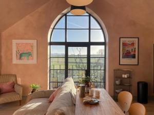 a living room with a couch and a large window at Olive in Kelsall