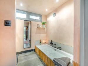 a large bathroom with a tub and a window at Olive in Kelsall