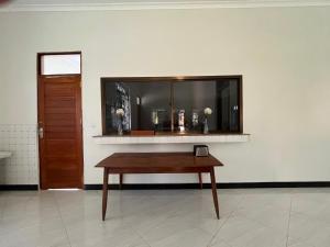 a table in a room with a mirror and a door at Charming Bungalows in Mwanza