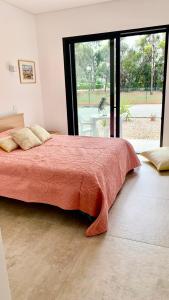 a bedroom with a large bed with a large window at Casa Penina in Portimão