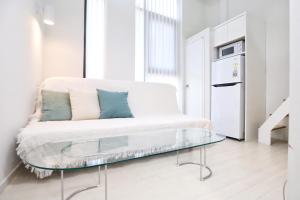 a white couch with a glass table in a room at Apartment J garden Myeongdong Station in Seoul