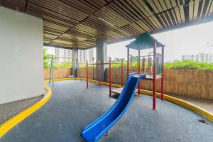 a playground with a slide in a building at RedLiving Apartemen Serpong Green View - Hapukh Room Tower B in Ciater-hilir