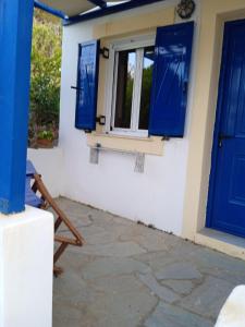 a room with blue doors and a window at Kouvaras Apartments in Kýthira
