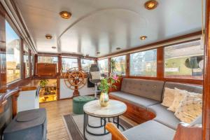 a living room of a boat with a couch and a table at The luxury Boat in Zwolle