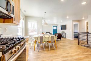 a kitchen and dining room with a table and a stove at Mountain-View Cedar City Home with Large Yard! in Cedar City