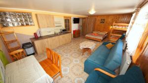 a living room with a blue couch and a kitchen at Agroturystyka U Matysa Wisła in Wisła