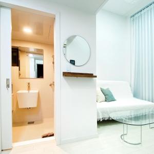 a bedroom with a mirror and a bed and a sink at Apartment J garden Myeongdong Station in Seoul +48 photos