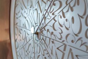 a close up of a clock on a wall at COMO Metropolitan London in London