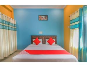 a bedroom with a large bed with red pillows at Morning Mist Homestay, Lansdowne in Lansdowne