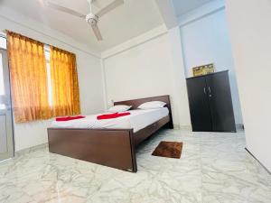 a bedroom with a bed with red pillows on it at Yala Visit Villa in Tissamaharama