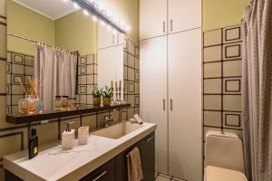 a bathroom with a sink and a mirror at Nickie's Vintage Home for 3 in Athens