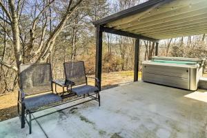 two chairs sitting on a porch with a piano at Pigeon Forge Cabin with Private Hot Tub and Gas Grill in Pigeon Forge