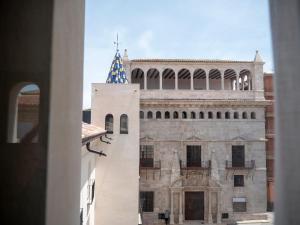 a building with a flag on top of it at Hotel Palacio La Marquesa 4 Estrellas SUP in Teruel