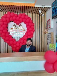 a man standing in front of a mirror with a heart at The Ashiyana Inn Hotel in Patna