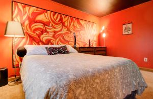a bedroom with a bed with a painting on the wall at Honey Spot in Springfield