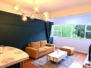 a living room with a couch and a table at Secure Modern 2 bed - excellently located in Cape Town