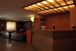 a lobby with a bar in a hotel with couches at Hotel Fly in Casoria