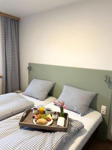 two beds with a tray of food on them at Bike Lodge Spessart in Lohr am Main