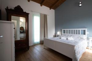 a bedroom with a large bed and a mirror at Agriturismo San Filippo Neri in Castignano +79 photos