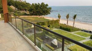 a balcony with a view of the beach and the ocean at Escape BestFamily Condo 1st Beach line in Ban Ang