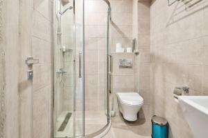 a bathroom with a shower and a toilet and a sink at Sea lounge in Varna City +37 photos