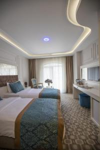 a large hotel room with two beds in it at Palde Hotel & Spa in Istanbul