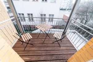 two chairs sitting on a balcony of a building at Full House Apartment MCity L10 in Magdeburg