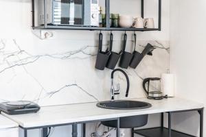 a kitchen with a sink and a counter with utensils at Guest house AllineedDubrovnik Choose between Double room or penthouse or studio apartments FREE PARKING in Dubrovnik