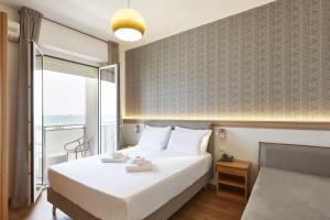 Postel nebo postele na pokoji v ubytování Hotel Tritone