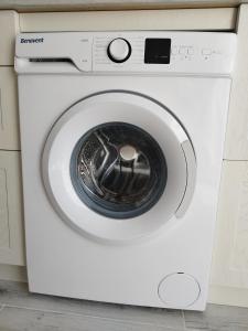 a white washing machine with its door open at RED in Puerto del Carmen
