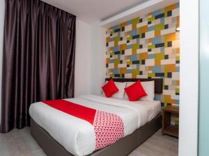 a bedroom with a large bed with red pillows at Big Big Hotel in Johor Bahru